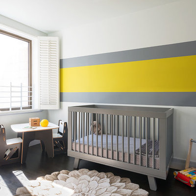 Nursery - contemporary gender-neutral dark wood floor nursery idea in New York with multicolored walls