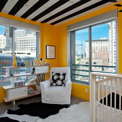Inspiration for a contemporary gender-neutral concrete floor nursery remodel in Seattle with orange walls