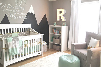 Large transitional boy light wood floor nursery photo in Austin with gray walls