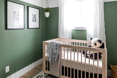 Small minimalist gender-neutral vinyl floor and brown floor nursery photo in Calgary with green walls