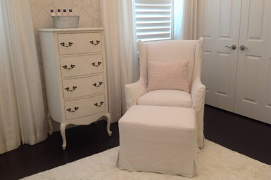 Example of a mid-sized cottage chic girl dark wood floor nursery design in Miami with beige walls