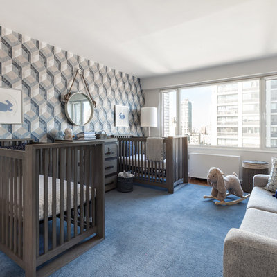 Inspiration for a mid-sized transitional boy medium tone wood floor and blue floor nursery remodel in New York with white walls