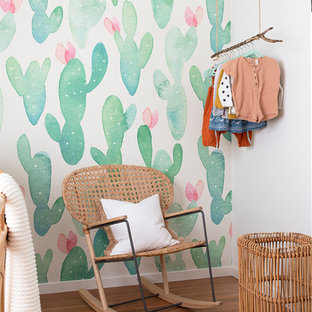 Beach style nursery in Gold Coast - Tweed with multi-coloured walls and medium hardwood floors for girls.