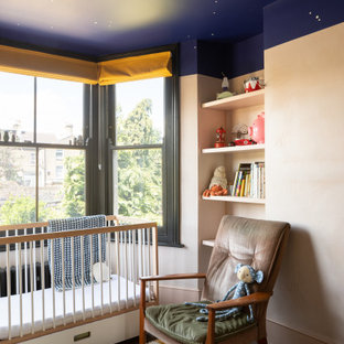 Inspiration for a bohemian nursery in London with beige walls, dark hardwood flooring and brown floors.