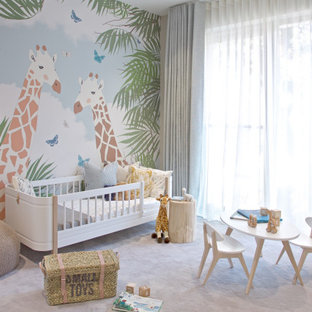 Large contemporary nursery for girls in London with grey walls, carpet and grey floors.