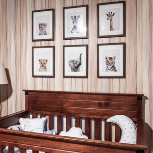 Immagine di una piccola cameretta per neonati neutra chic con pareti verdi, pavimento in bambù, pavimento beige e carta da parati