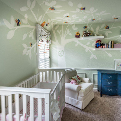 Inspiration for a large transitional girl carpeted nursery remodel in Houston with green walls