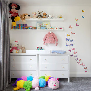 Medium sized contemporary nursery for girls in Kent with carpet, grey floors and white walls.