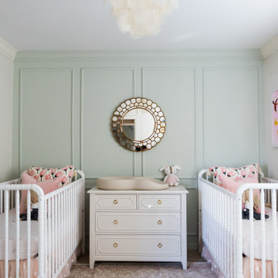 Example of a mid-sized transitional girl medium tone wood floor and beige floor nursery design in Orlando with green walls