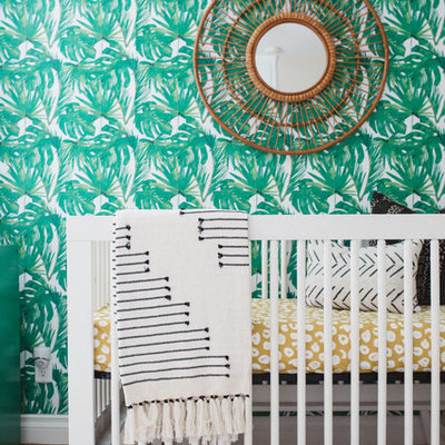 Example of a mid-sized trendy gender-neutral medium tone wood floor and brown floor nursery design in Orange County with beige walls