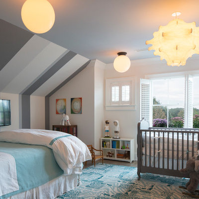 Mid-sized elegant boy dark wood floor nursery photo in New York with white walls