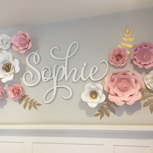 Mid-sized elegant girl carpeted and beige floor nursery photo in Chicago with beige walls