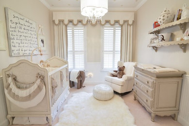 Example of a mid-sized transitional gender-neutral carpeted nursery design in Orlando with beige walls