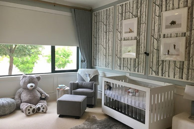 Example of a transitional boy carpeted nursery design in Phoenix with blue walls