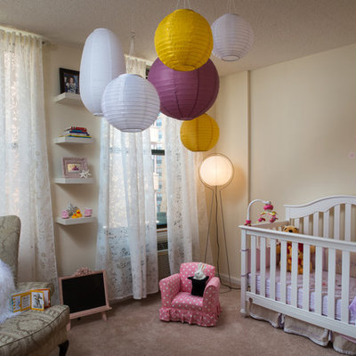 Example of a transitional girl carpeted nursery design in New York with beige walls