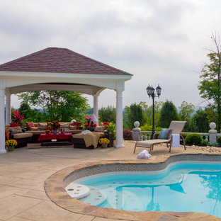 Inspiration for a large transitional backyard stone patio kitchen remodel in Boston with a gazebo