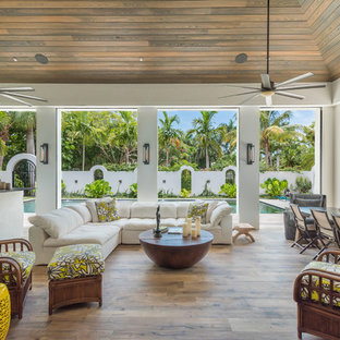 Patio kitchen - large tropical backyard patio kitchen idea in Miami with decking and a roof extension