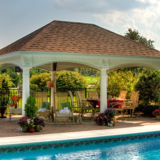 Example of a large transitional backyard stone patio kitchen design in Boston with a gazebo