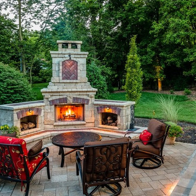 Example of a classic brick patio design in Other with a fire pit