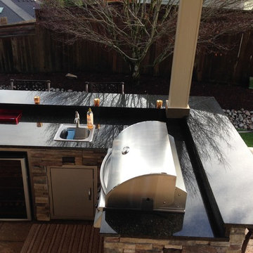 2014 Custom outdoor kitchen and matching fire table granite tops.