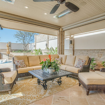 Example of a mid-sized classic backyard tile patio design in Austin with a roof extension