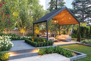 Inspiration pour une terrasse design avec une cuisine d'été, une dalle de béton et un gazebo ou pavillon.