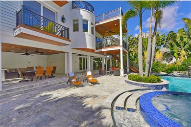 Inspiration for a large nautical back patio in Tampa with tiled flooring and a roof extension.