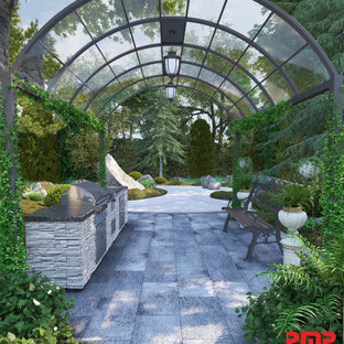 Idee per un patio o portico vittoriano di medie dimensioni e dietro casa con pavimentazioni in mattoni e un gazebo o capanno
