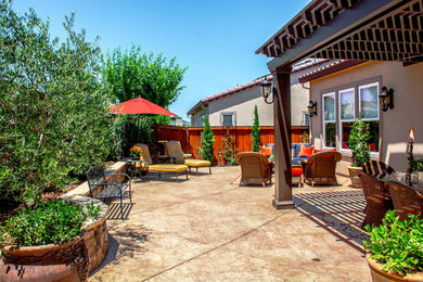 Inspiration for a large timeless backyard concrete paver patio kitchen remodel in San Francisco with a gazebo