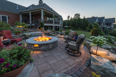 Patio - large transitional backyard tile patio idea in Cleveland with a fire pit and no cover