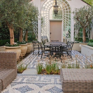 Inspiration for a medium sized mediterranean back patio in Hertfordshire with no cover and a potted garden.