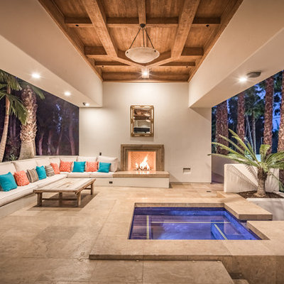 Example of a huge trendy backyard tile patio design in San Diego with a roof extension and a fireplace