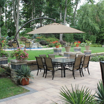 A patio with outdoor kitchen and pool