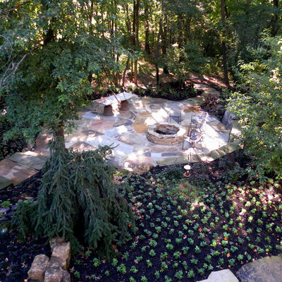 Patio - huge traditional backyard stone patio idea in Chicago with a fire pit