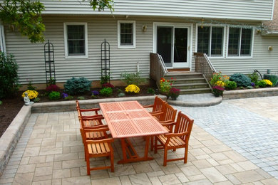 Inspiration for a transitional backyard concrete paver patio remodel in New York