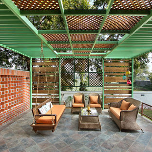 Design ideas for a mid-sized traditional backyard patio in Ahmedabad.