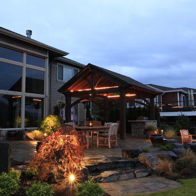 Inspiration for a mid-sized timeless backyard stone patio remodel in Seattle with a pergola
