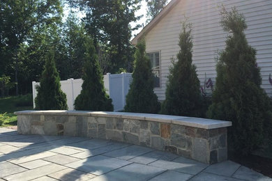 Small classic back patio in DC Metro with natural stone paving.