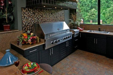 Inspiration for a large contemporary backyard tile patio kitchen remodel in Jacksonville with a roof extension