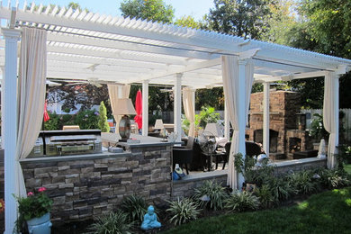 Patio - mid-sized traditional backyard stone patio idea in Richmond with a pergola and a fire pit