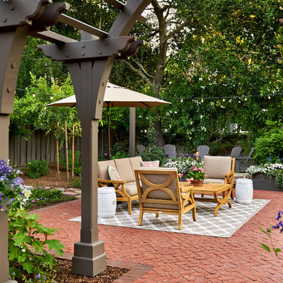 Example of a huge classic backyard brick patio design in San Francisco with a pergola