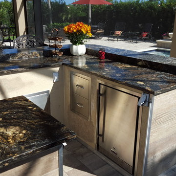 Angled 2-piece kitchen with wood tile exterior and granite countertops
