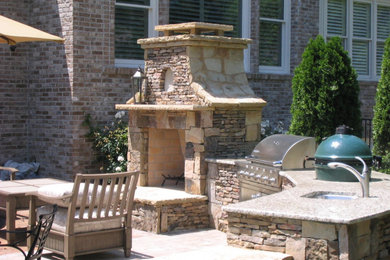 Mid-sized cottage backyard stone patio kitchen photo in Atlanta with no cover
