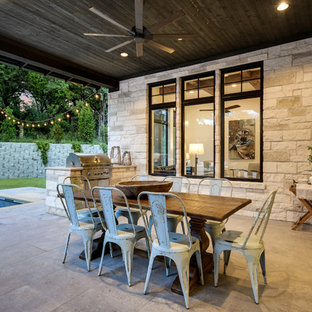 Foto di un patio o portico country dietro casa con lastre di cemento e un tetto a sbalzo