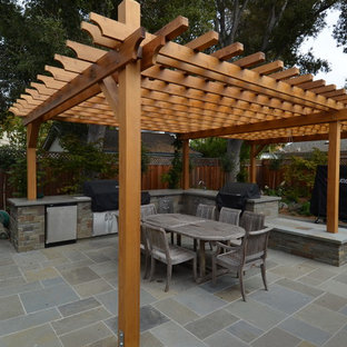 Inspiration for a mid-sized timeless backyard tile patio kitchen remodel in San Francisco with a pergola