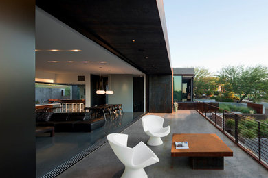 Patio - large contemporary backyard concrete patio idea in Phoenix with no cover