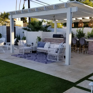 Idee per un patio o portico country di medie dimensioni e dietro casa con piastrelle e una pergola