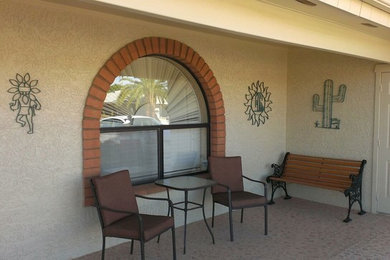 Example of a mid-sized southwest backyard patio design in Other with a roof extension