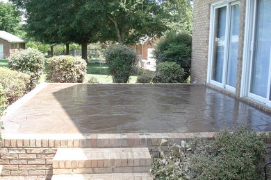 Design ideas for a medium sized back patio in Charlotte with stamped concrete.