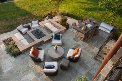 Design ideas for a medium sized modern back patio in DC Metro with an outdoor kitchen, stamped concrete and no cover.